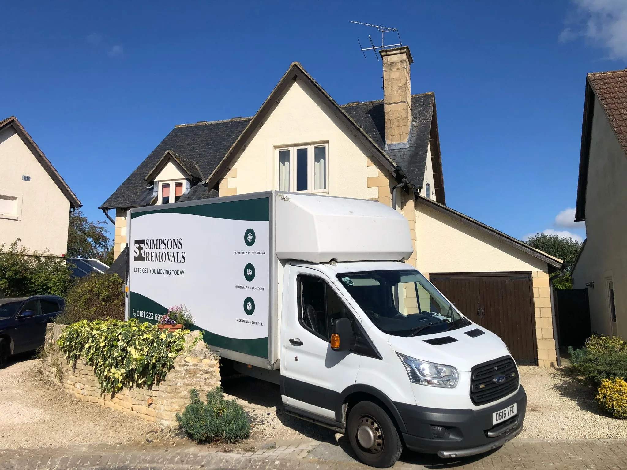Simpsons Removals van parked outside a detached house ready for a home move
