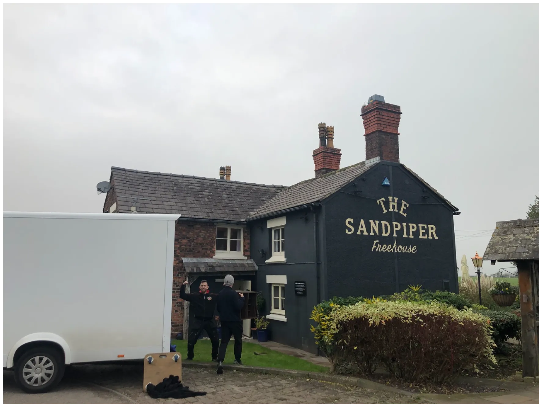 Removal team loading a van outside The Sandpiper pub